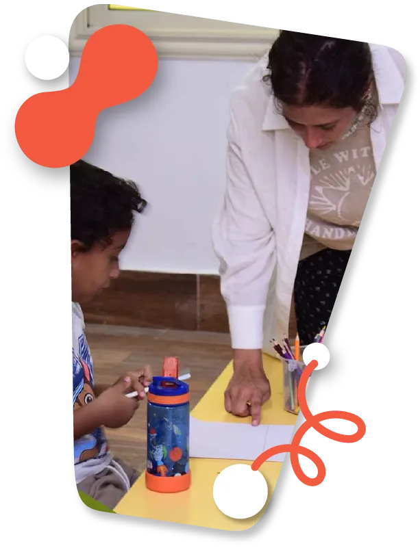 picture of a woman teaching a child at a table during a Global Volunteer programme
